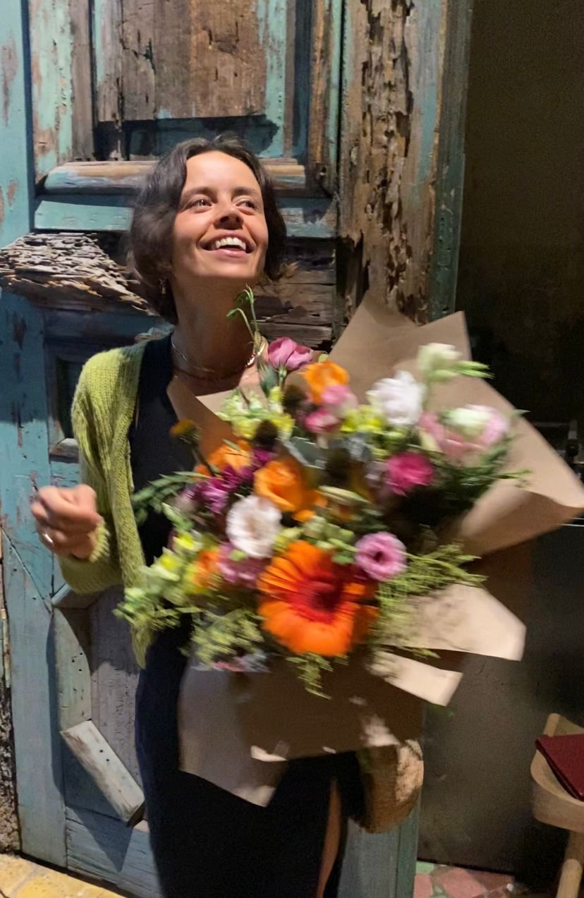 Woman smiling with an armful of flowers