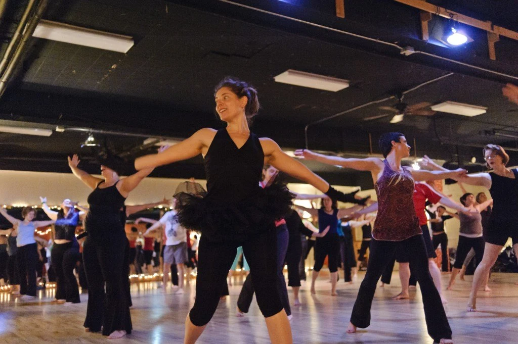 Dancers sharing a wooden studio floor at Dance Underground in Seattle