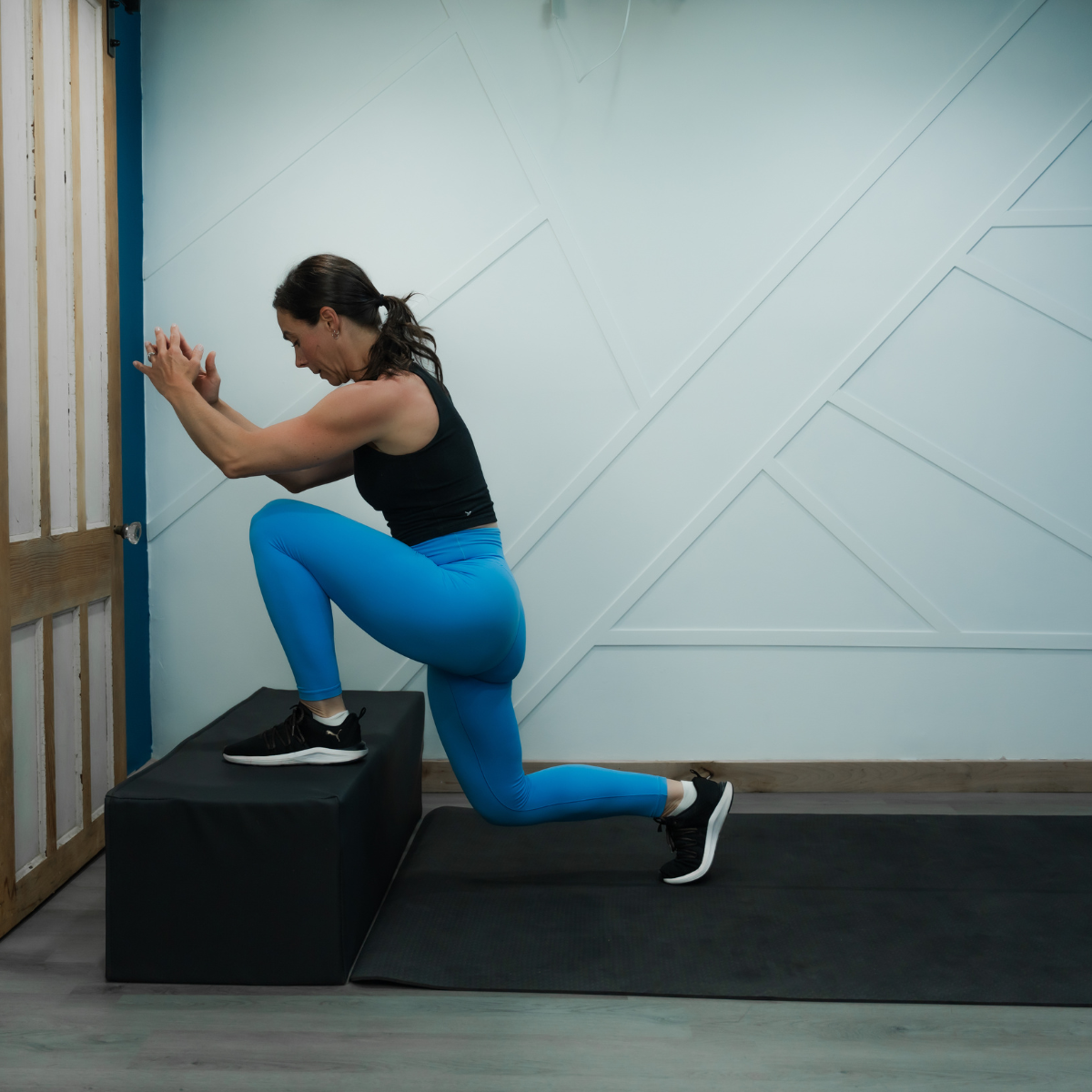 Angela performing a jump lunge onto a box