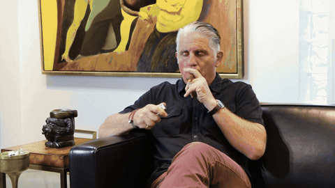 Mark Ford sitting thoughtfully in a leather chair