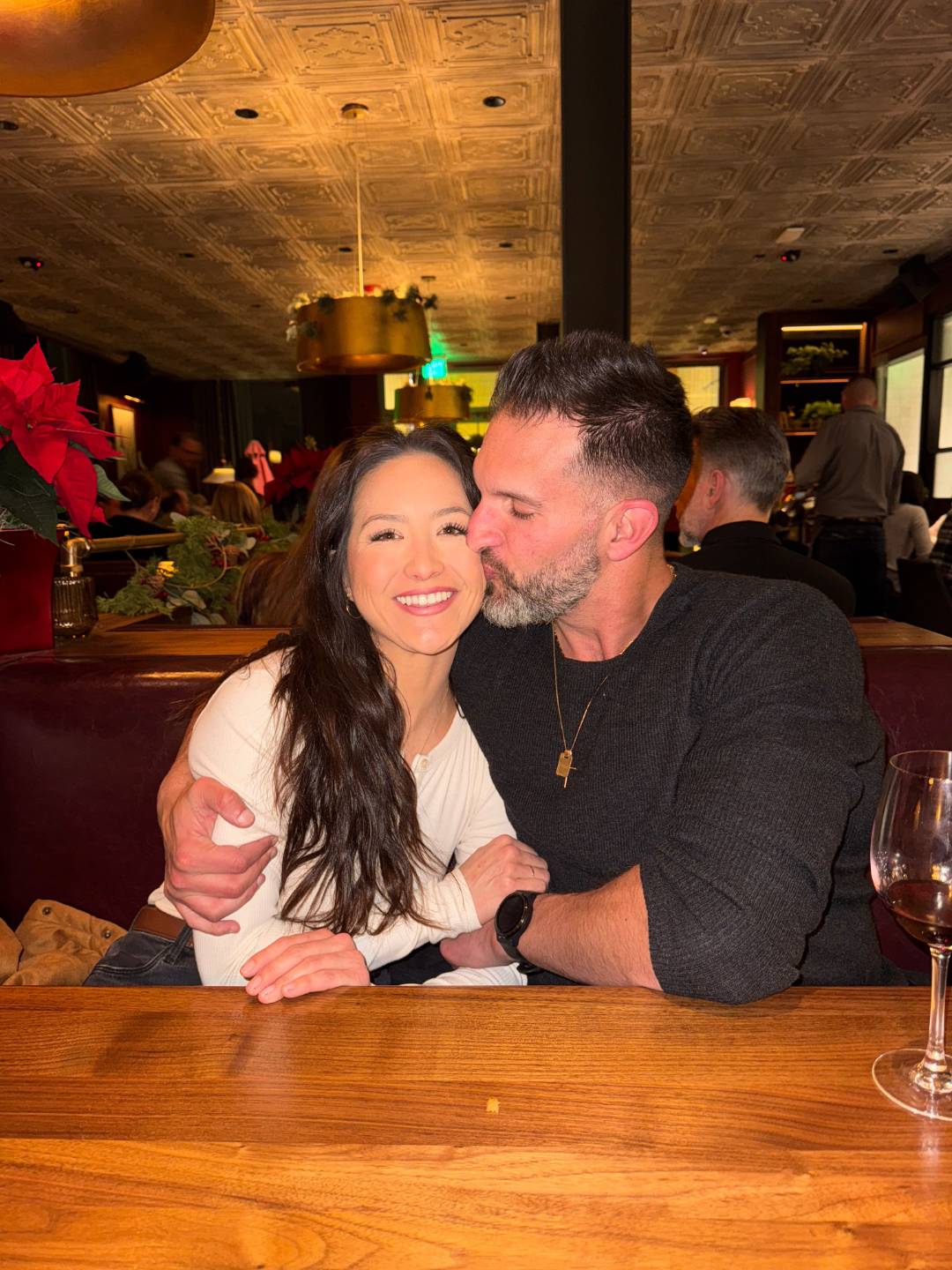 Vince embracing Ellie at a restaurant