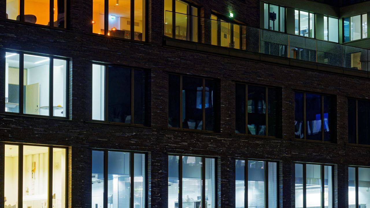 Office building at night with lit windows