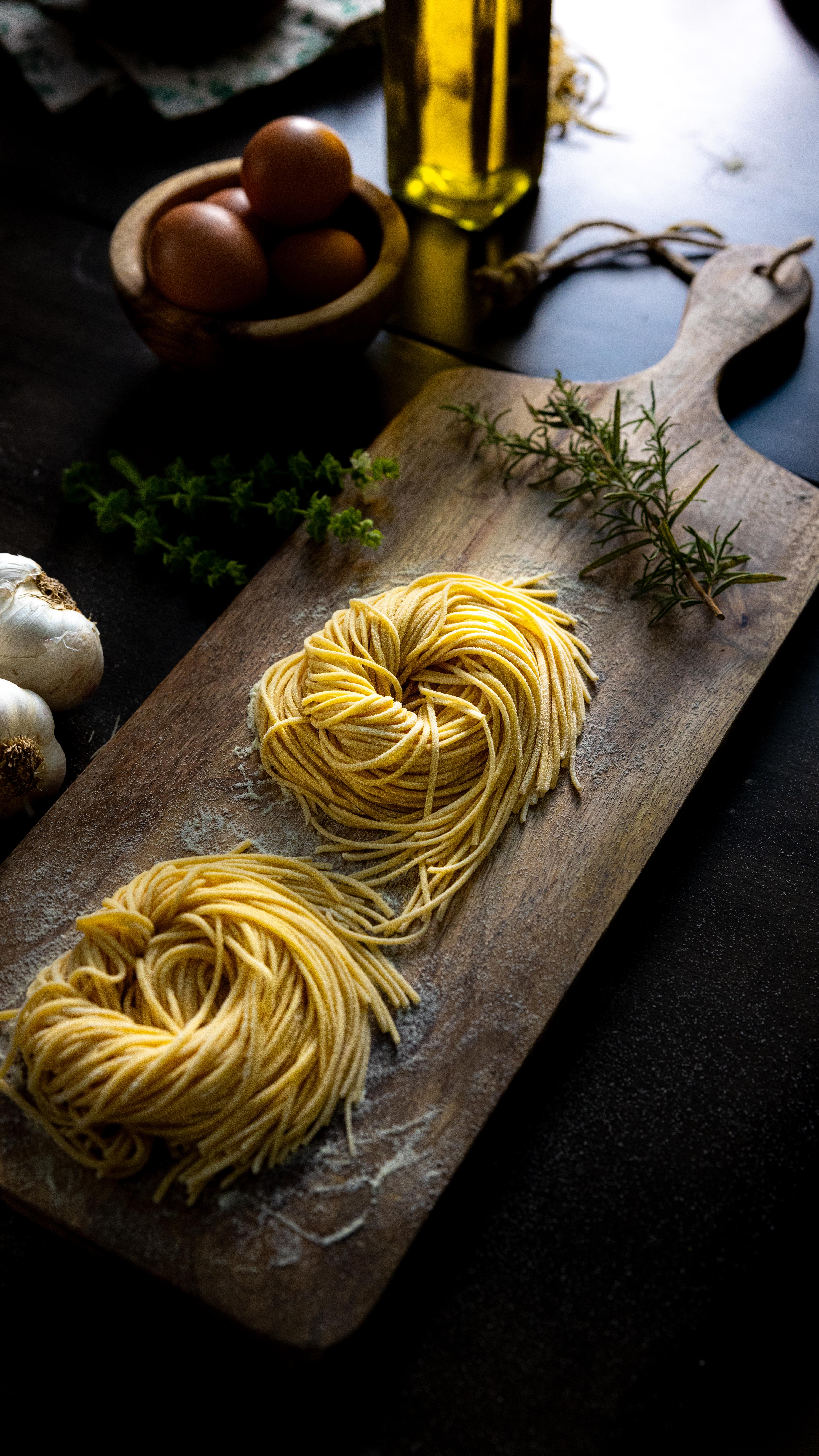 Fresh pasta nests on a wooden board
