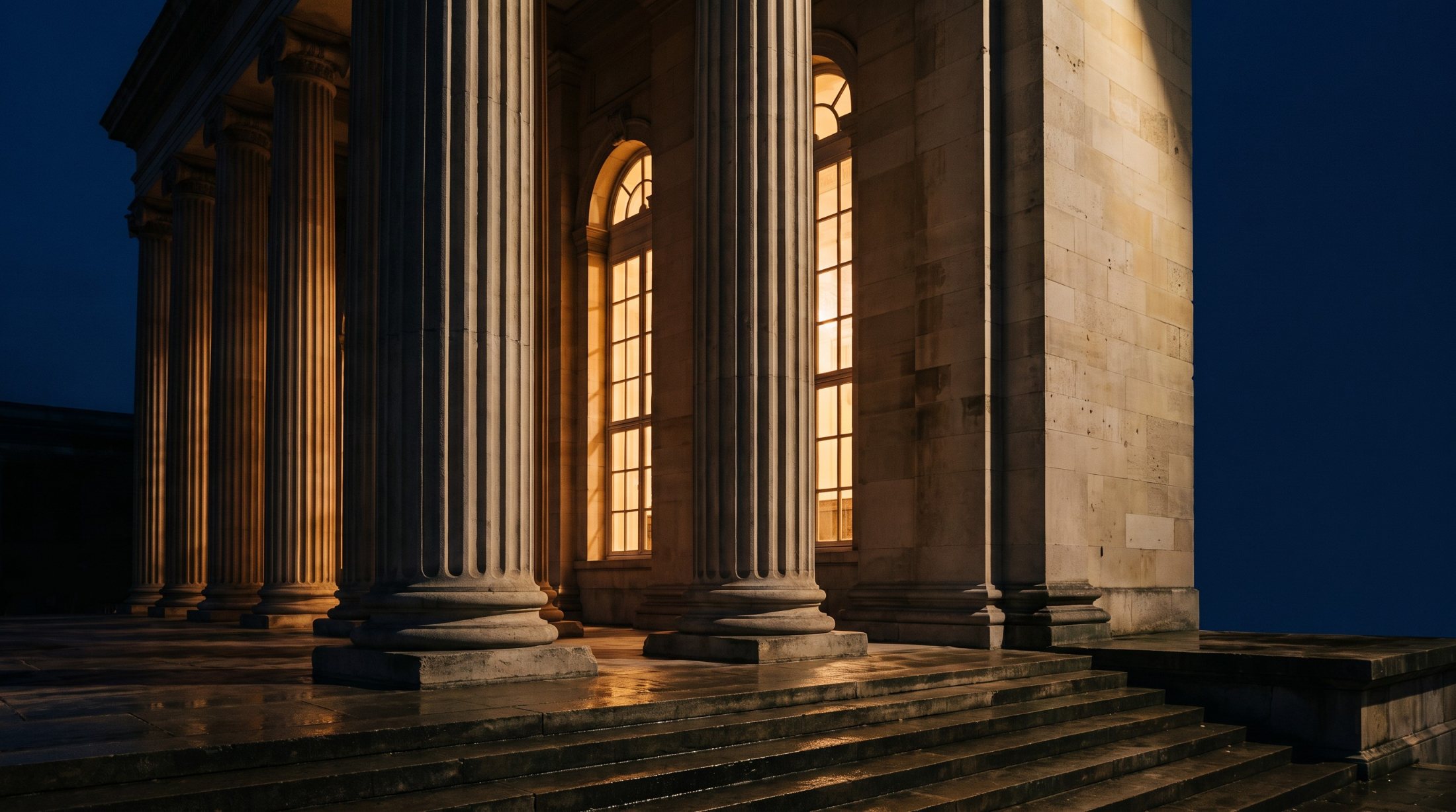 Private Equity Masterclass (PEMC): a stone colonnade at dusk