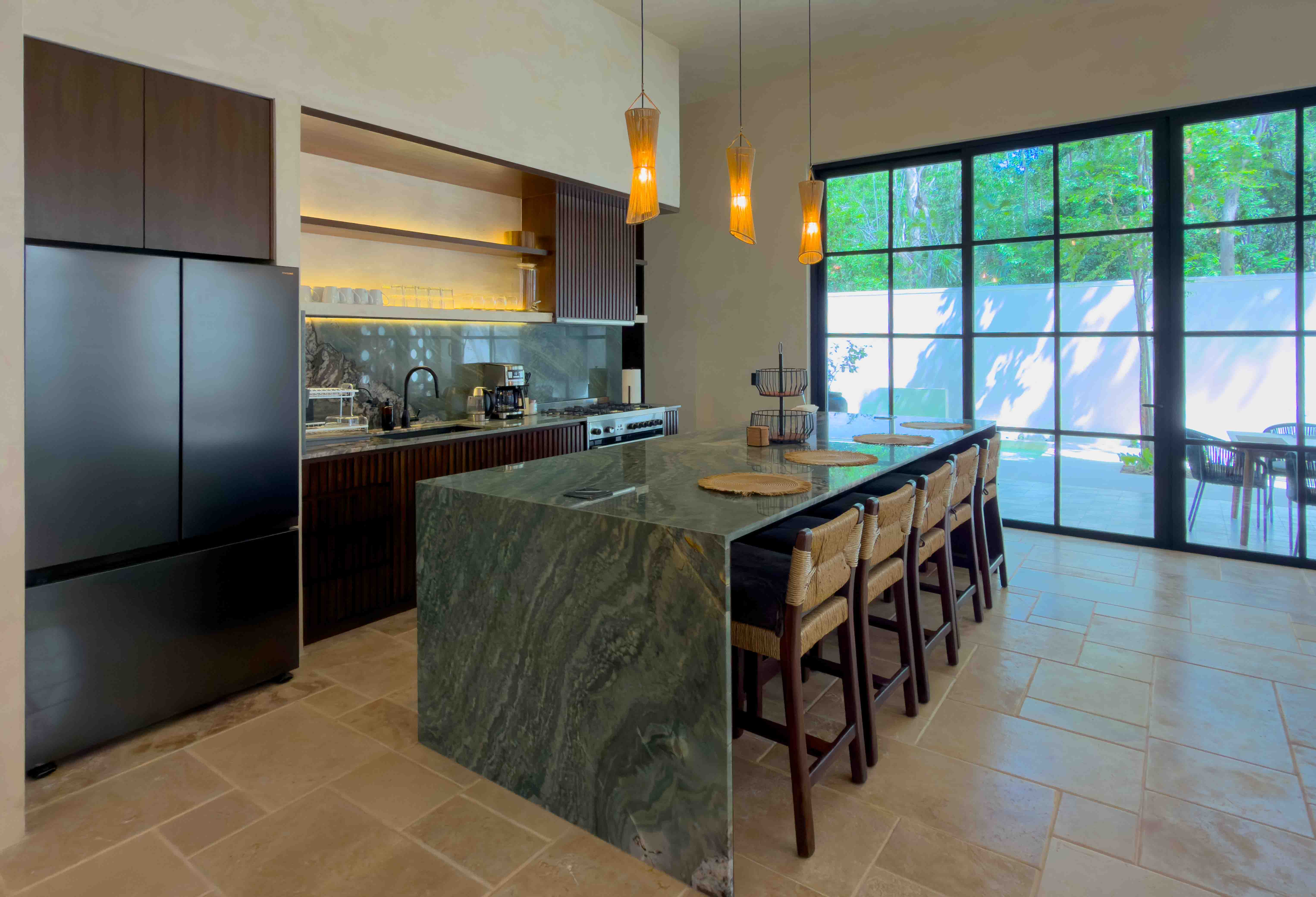 Chef's kitchen with a green marble waterfall island