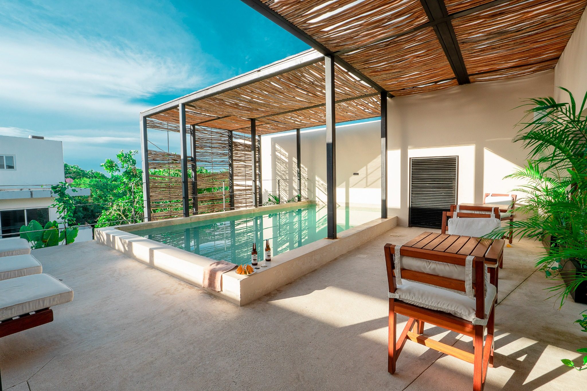 Rooftop pool and lounge at the Bohemian La Veleta building in Tulum