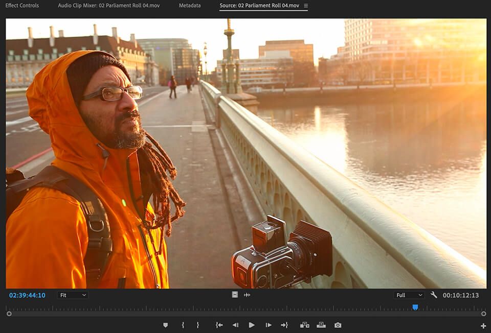 Filmmaker capturing morning light on a city bridge, part of the raw footage provided in the Inside The Edit editing course.