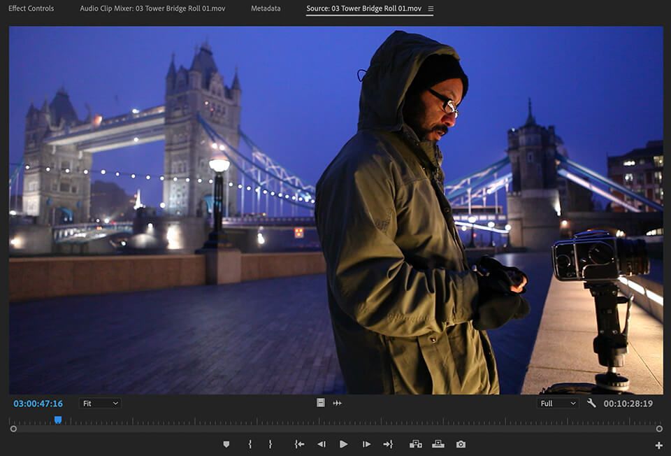 Behind-the-scenes view of a filmmaker capturing Tower Bridge at night, included in Inside The Edit’s documentary raw footage