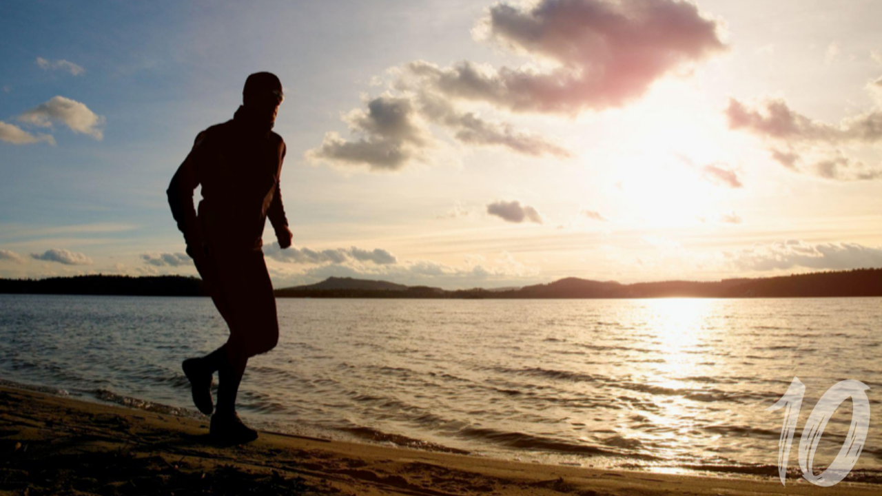 Bald man running silhouette at sunset representing future self clarity and direction