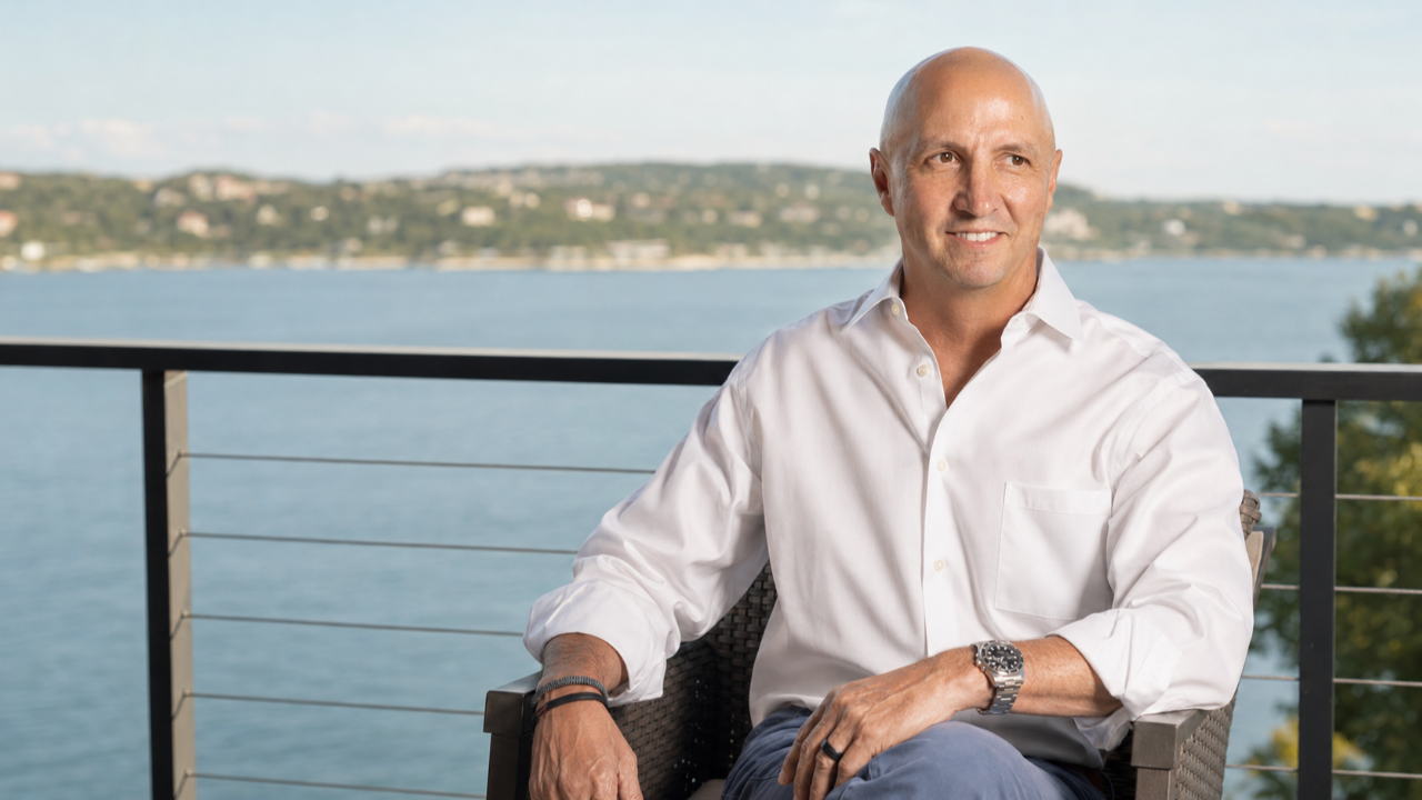 Craig Zuber sitting outdoors overlooking the water, reflecting on identity beyond his professional title.