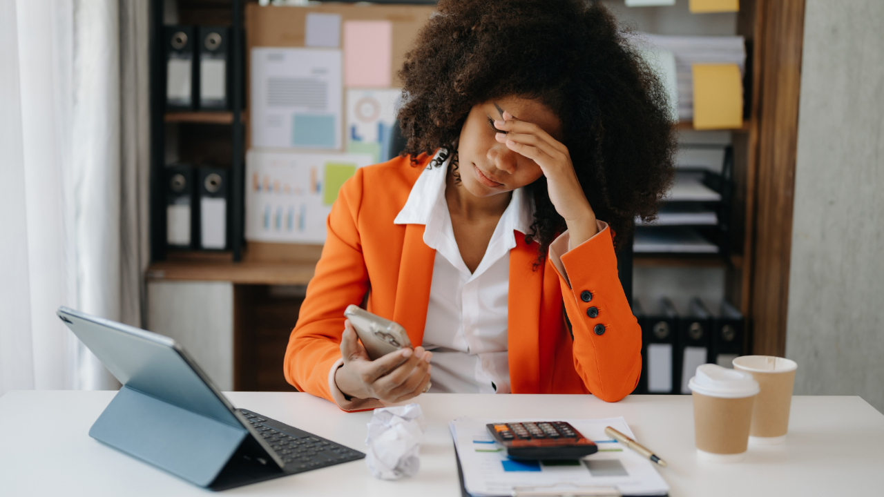 Woman feeling frustrated reviewing normal lab results despite experiencing fatigue, brain fog, and chronic symptoms