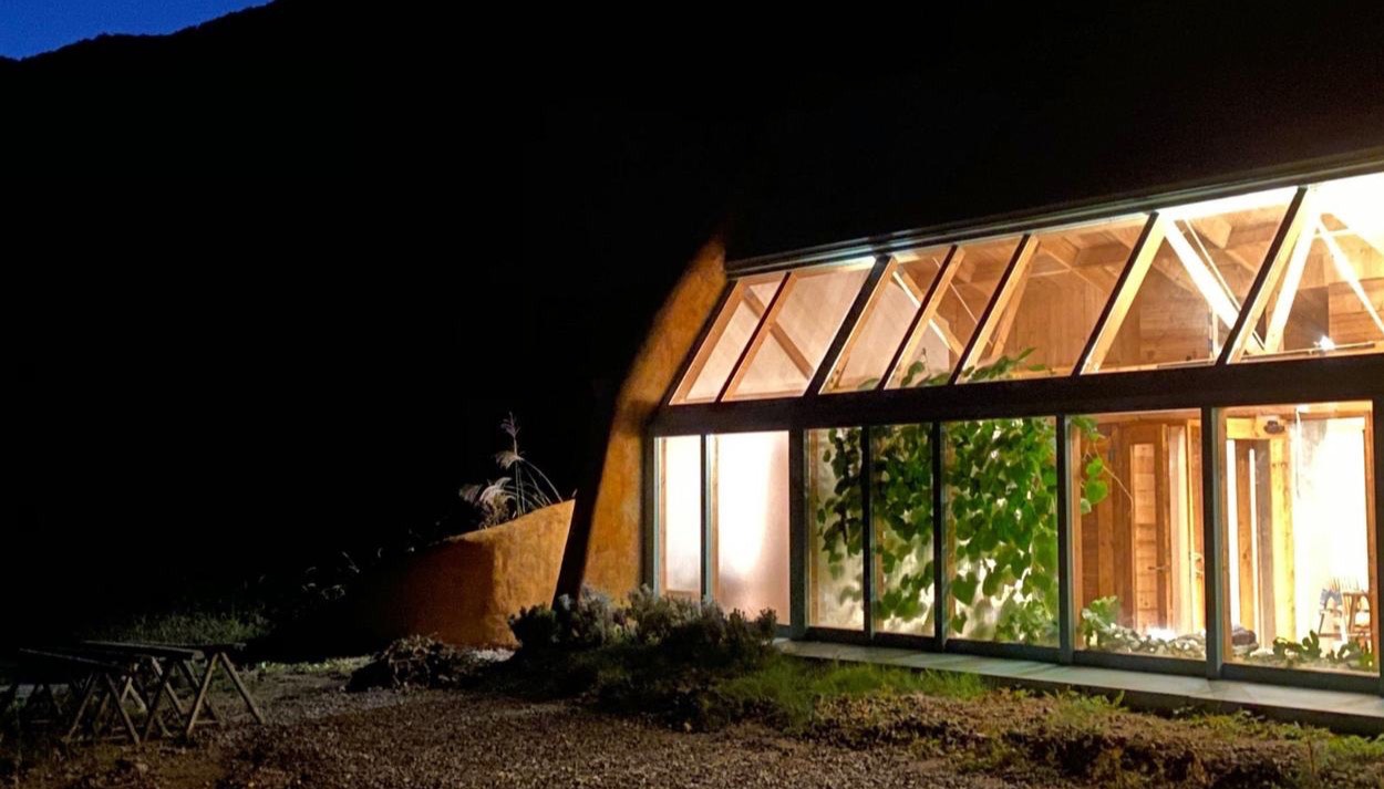 A guest house lit up at night in a Japanese forest