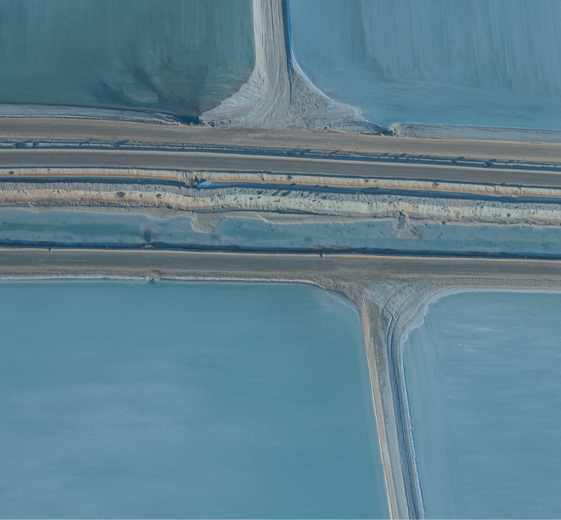 Aerial landscape of intersecting roads and salt formations in Western Australia