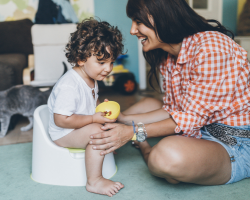 mother with toddler sat on the potty