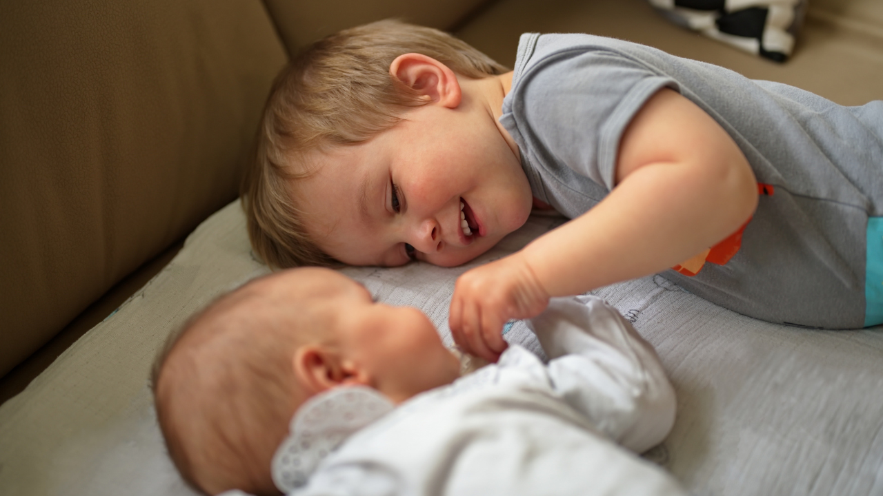 Newborn with toddler sibling