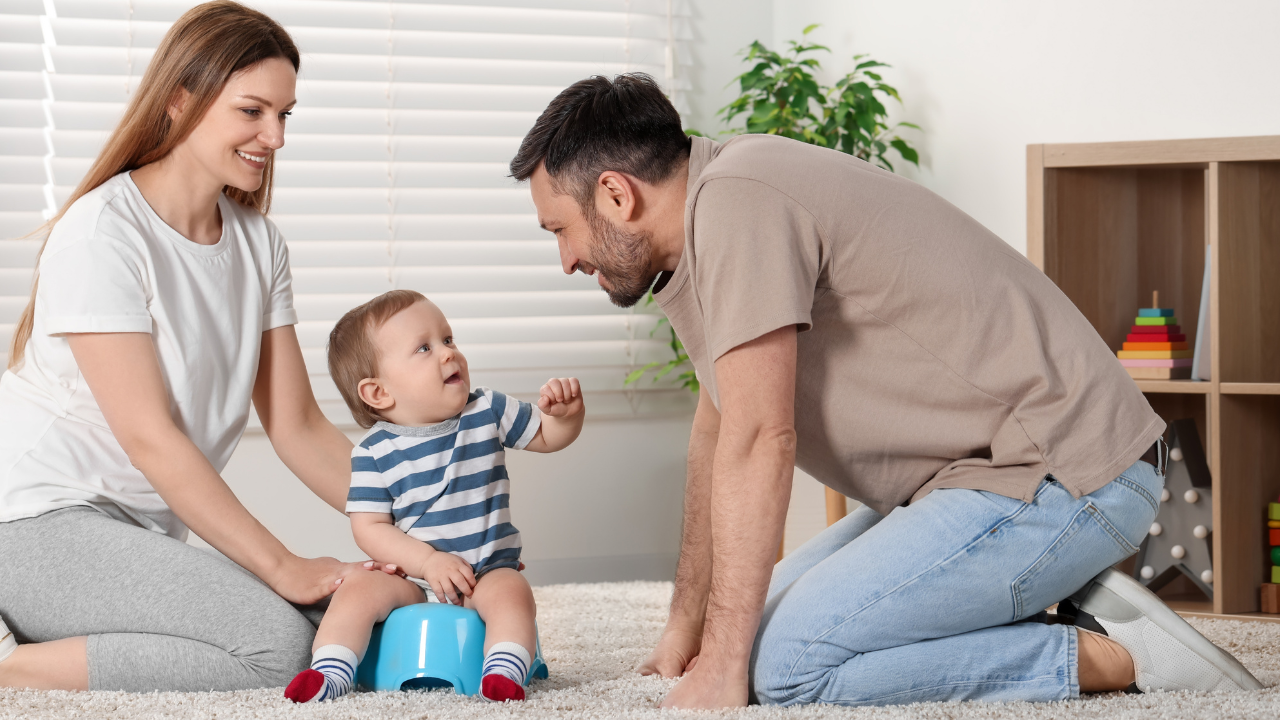 Mum and Dad looking at toddler on the potty