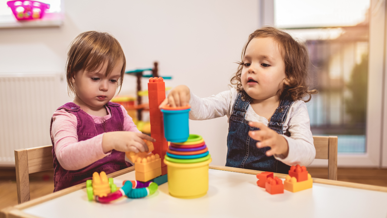 Two toddlers play at their nursery daycare