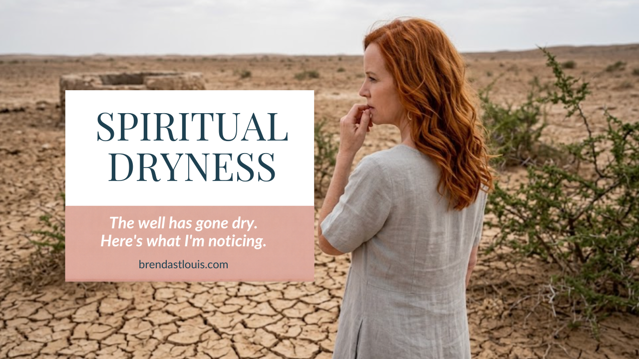 A woman in a linen dress stands beside an old stone well in a cracked, dry desert landscape, looking off into the distance
