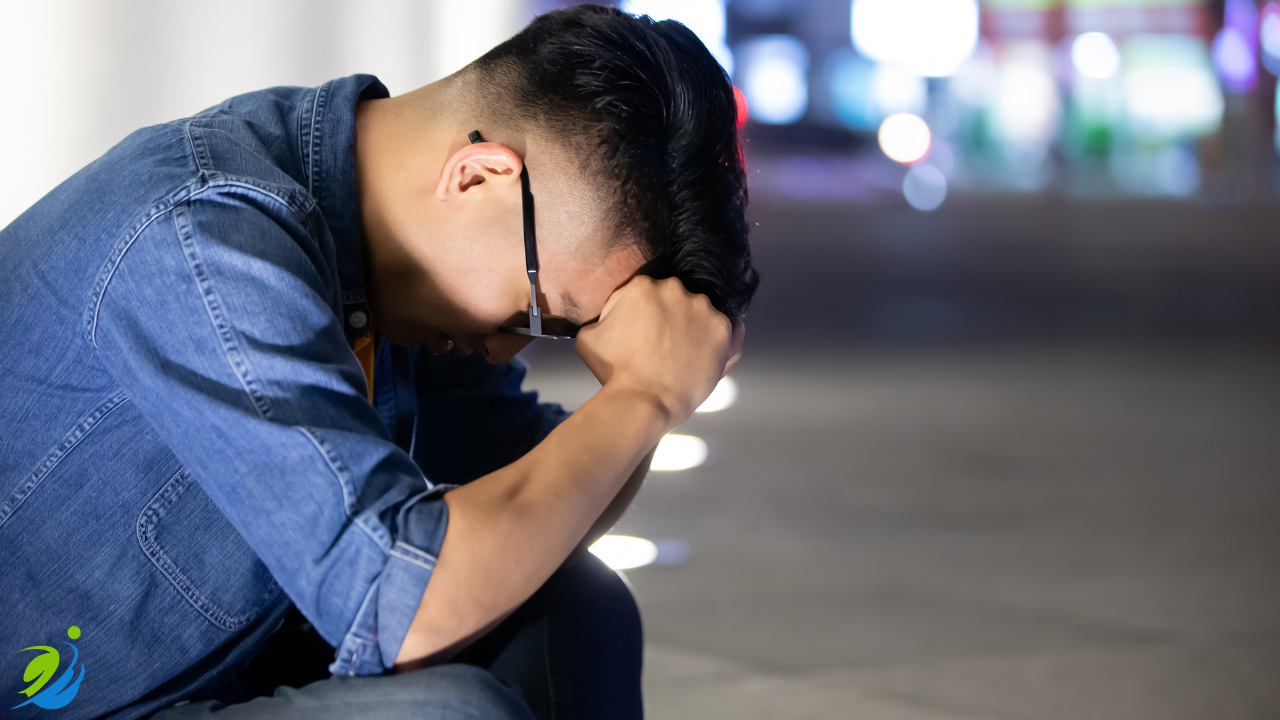 Man sitting alone at night with head in hands, showing stress and anxiety after a  restaurant workplace incident or legal issue, representing the consequences of lacking safety documentation.