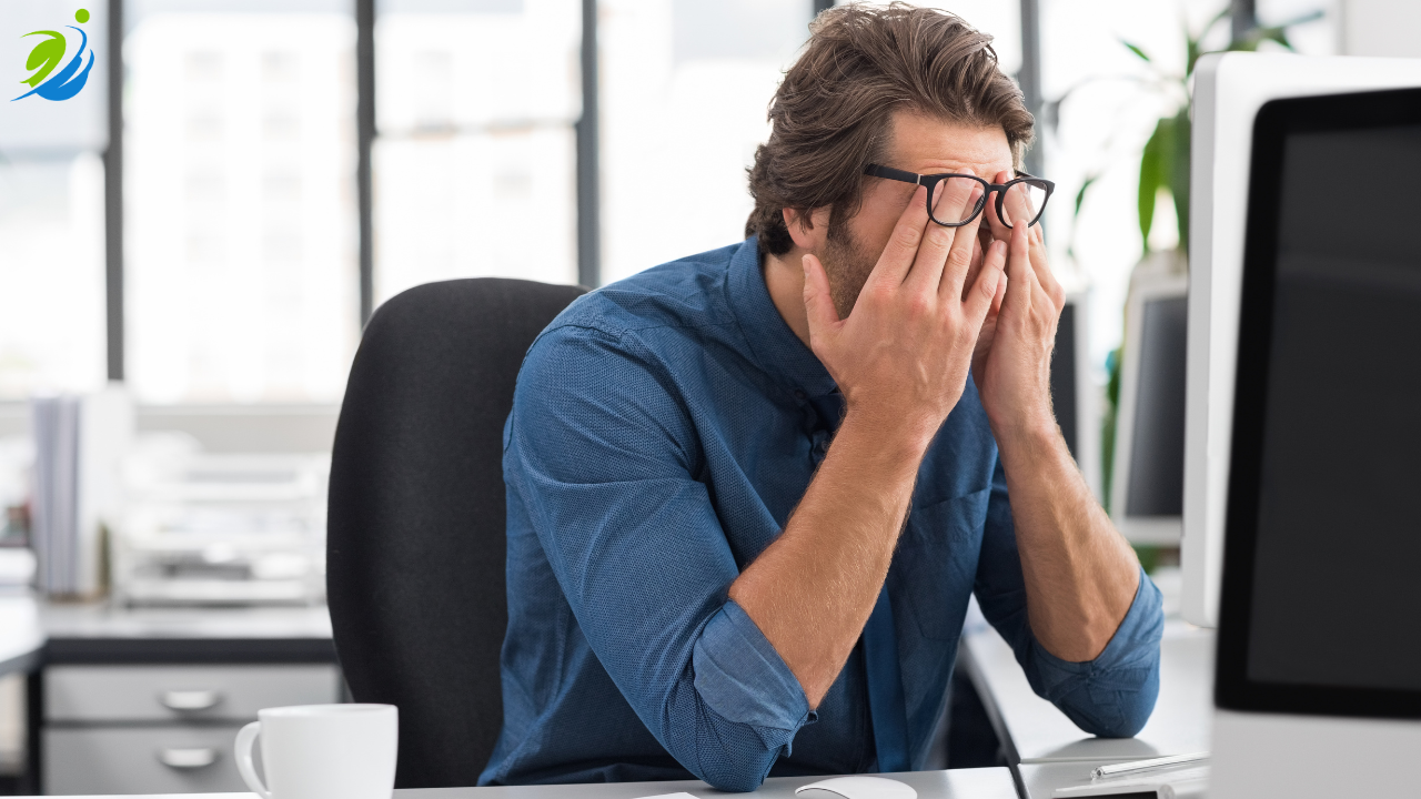 A stressed restaurant manager sits at a desk with their face in their hands, overwhelmed by the hidden financial and operational costs that workplace injuries can create for a restaurant.