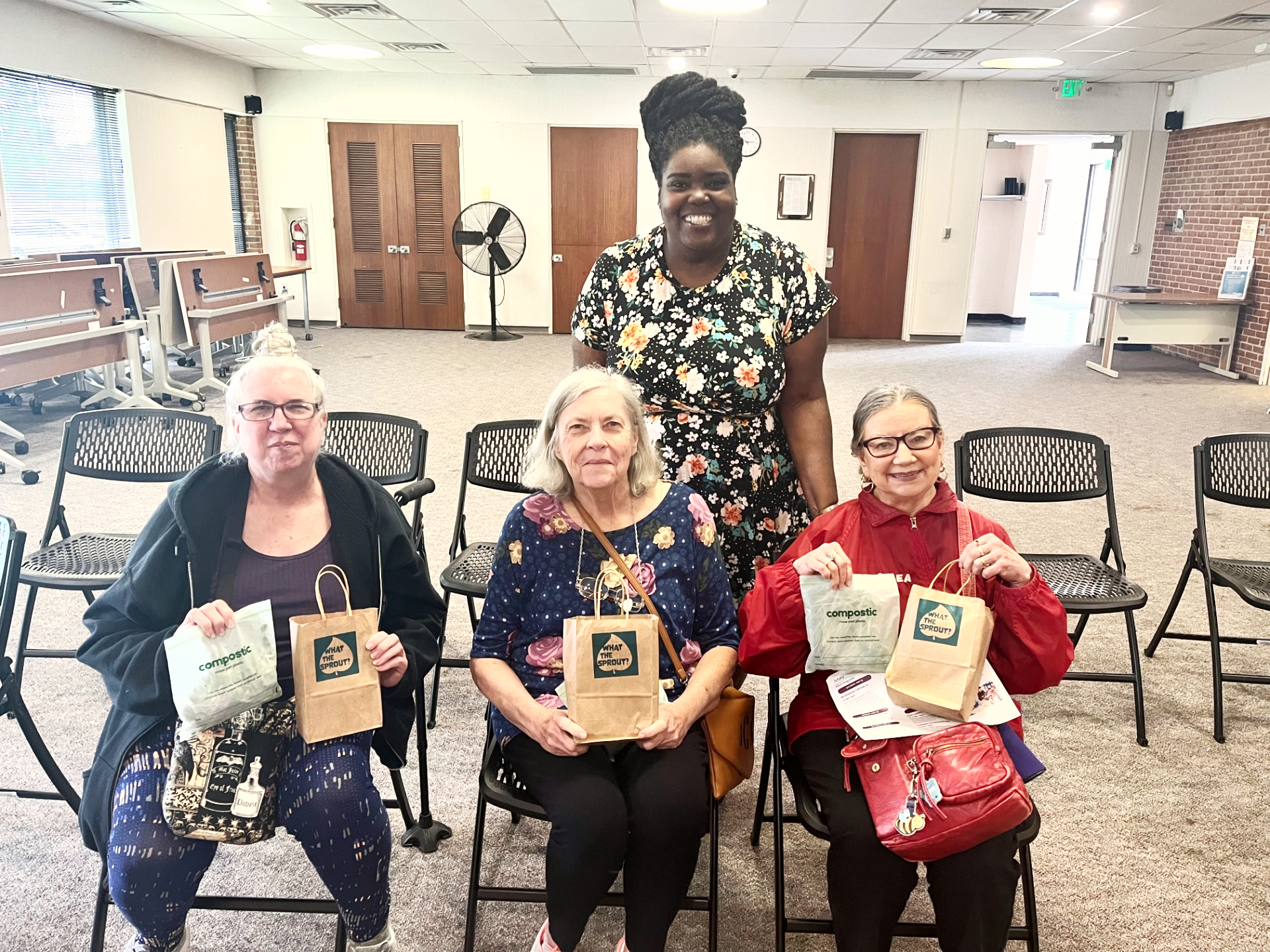 Quandra with participants holding microgreens workshop gift bags