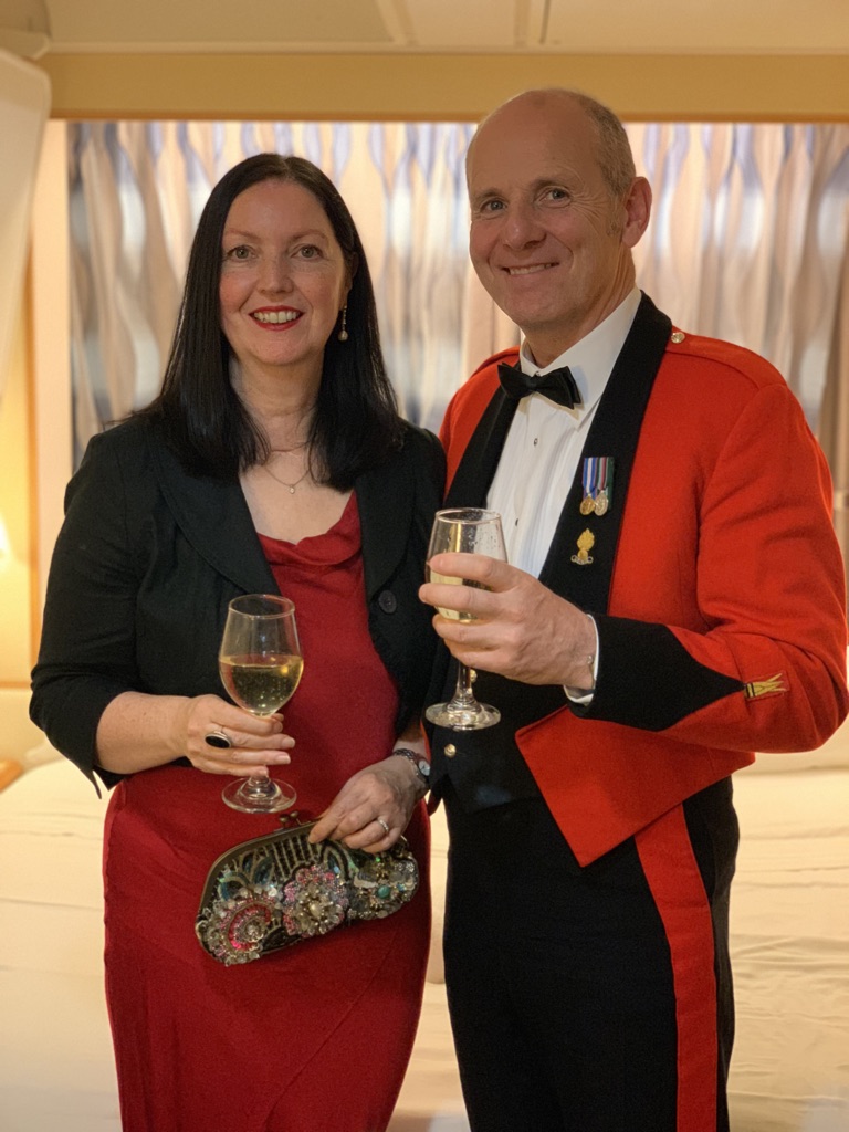 Joe O'Connor in Army mess dress with his wife at a formal dinner