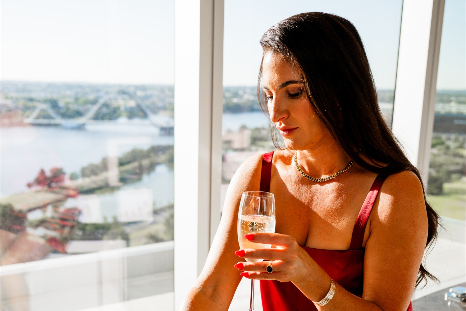 Michelle Rule with champagne in the penthouse, High Flyers