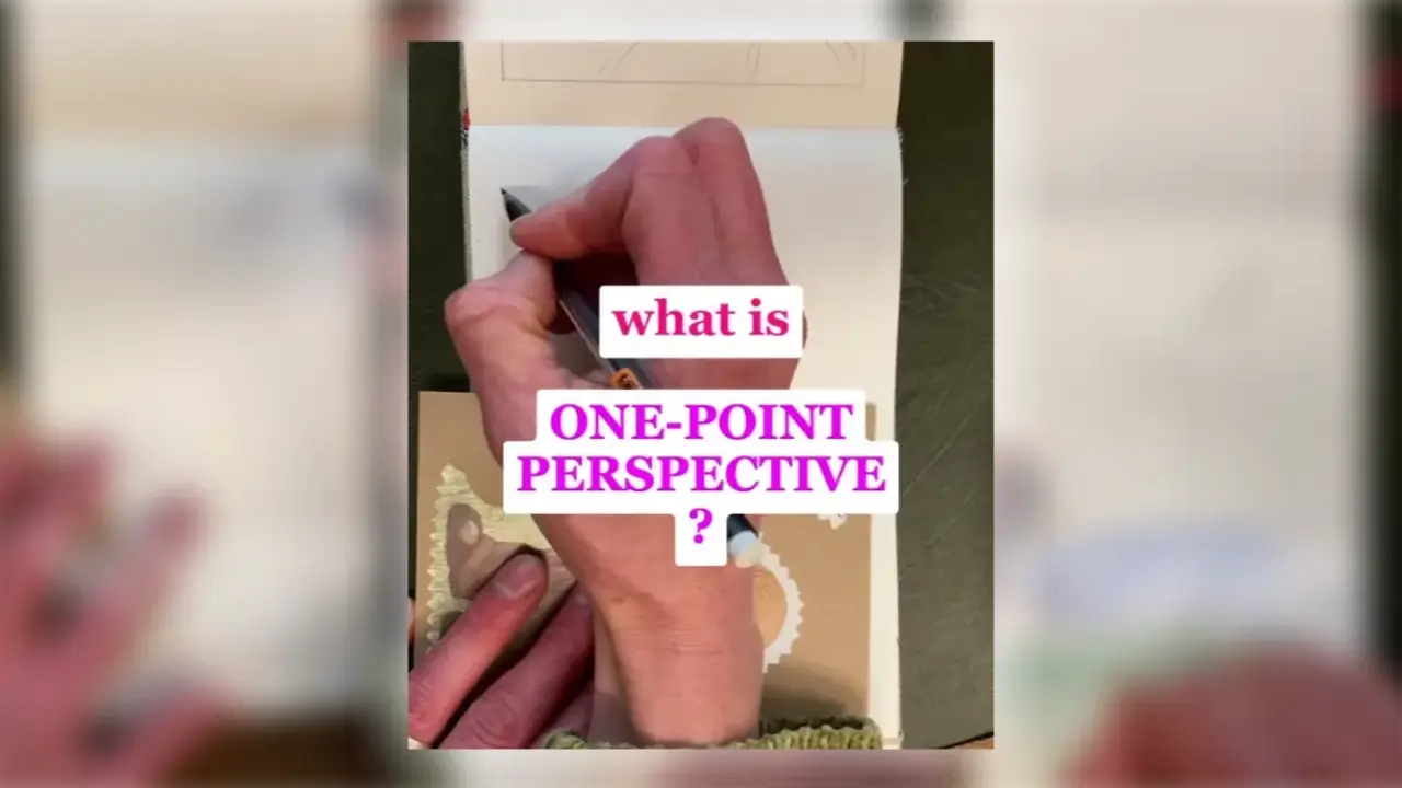 Artist Juliene holds a pencil over paper while sketching a landscape with a watercolor painting reference nearby, demonstrating how to use one-point perspective in watercolor.