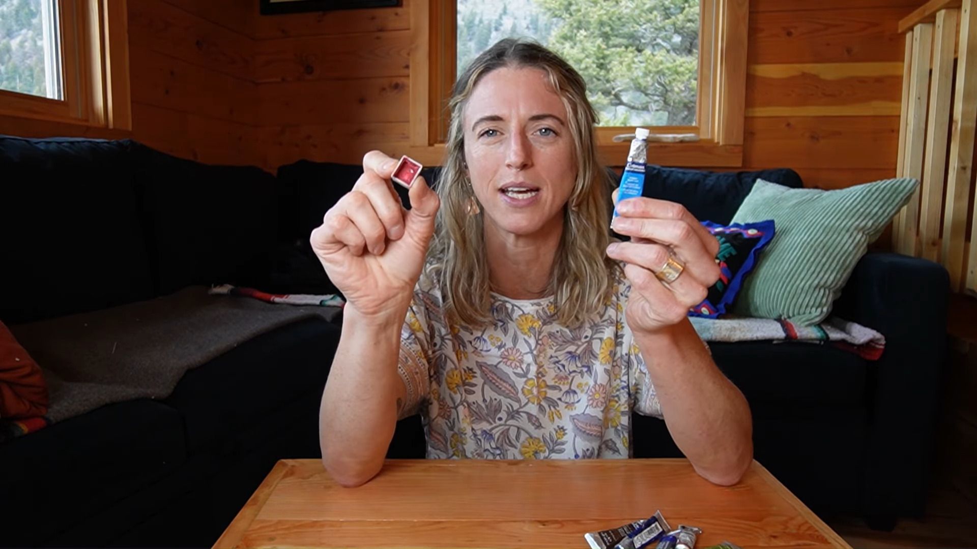 Juliene, a watercolor artist comparing paint pans and paint tubes to explain the differences between each format.