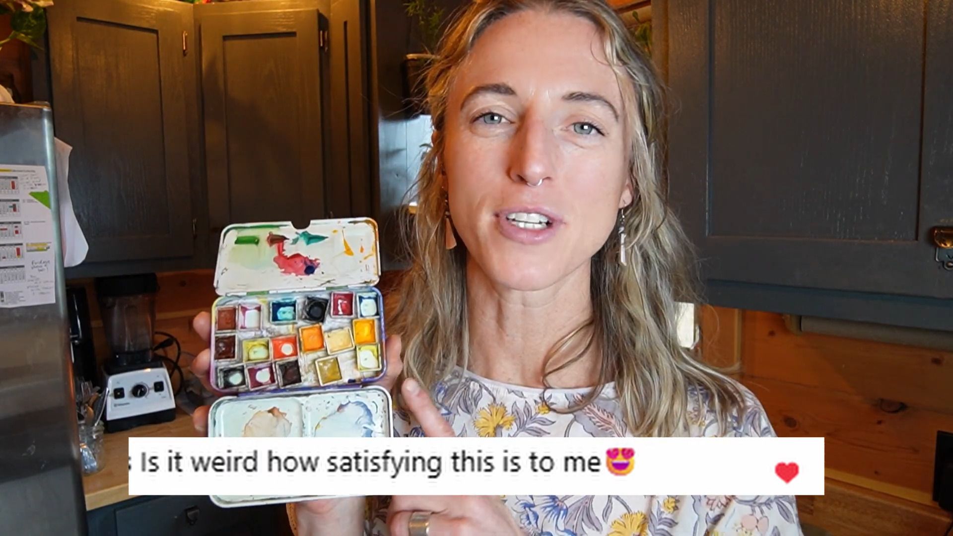 Juliene, a watercolor artist showing a palette of refilled watercolor pans during a step-by-step paint refill demonstration.
