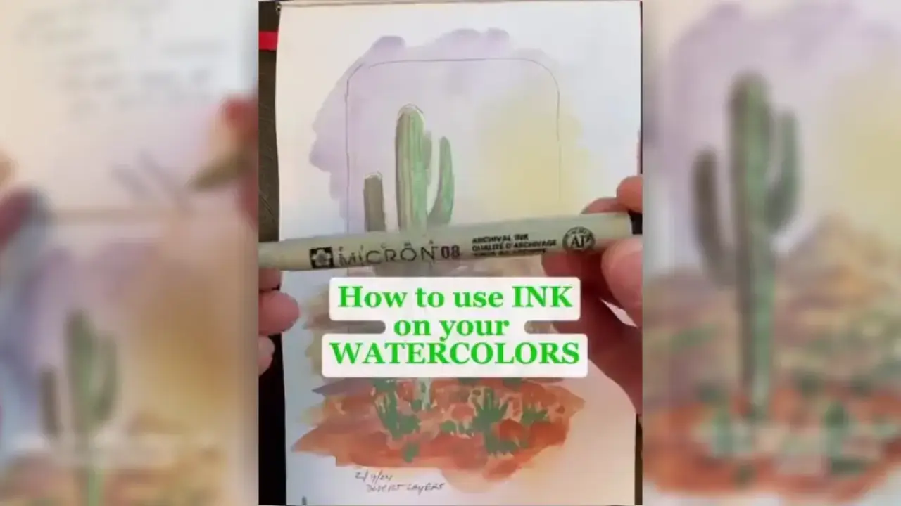Artist Juliene holding a Micron pen over a watercolor cactus painting, demonstrating how to use a Micron pen with watercolor to add crisp details and clean line work.