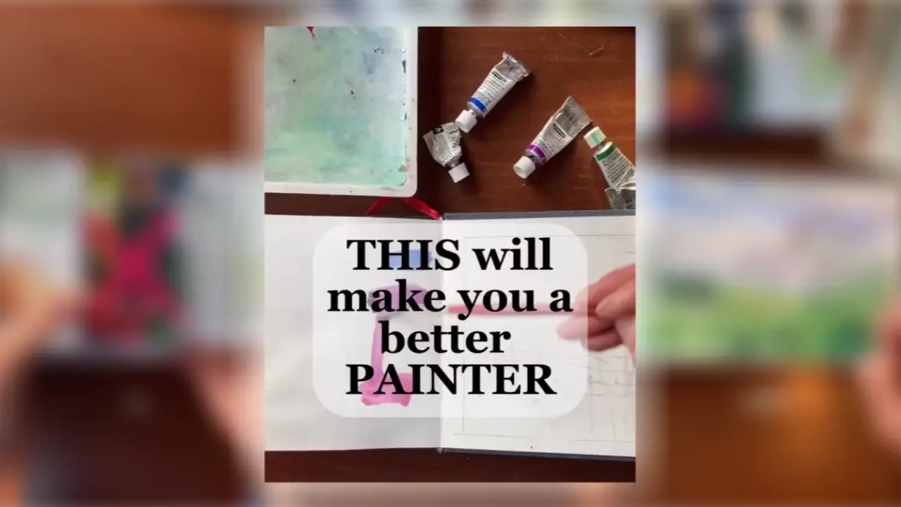 Watercolor paint tubes, a mixing palette, and a sketchbook on a wooden table illustrate Juliene’s limited palette watercolor technique for improving color mixing and painting skills.