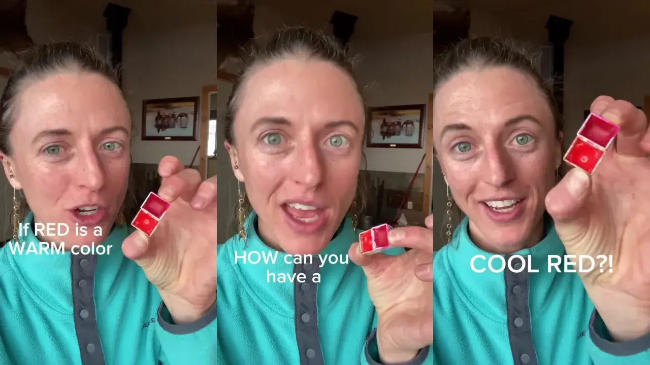 Juliene holds two red watercolor paint pans, comparing warm and cool reds to explain color temperature in watercolor painting.
