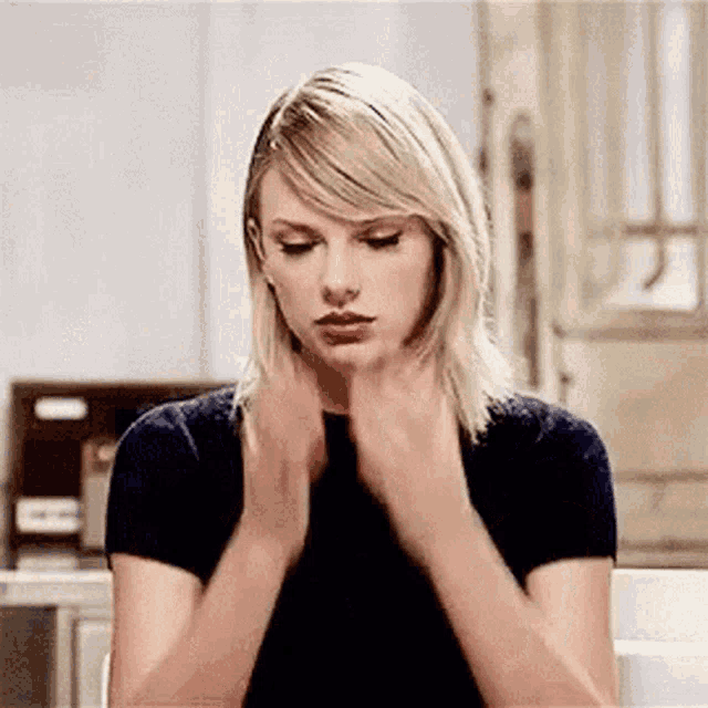 taylor-swift-slow-face-palm-gif GIF of Taylor Swift doing a slow, dramatic face palm with a serious expression