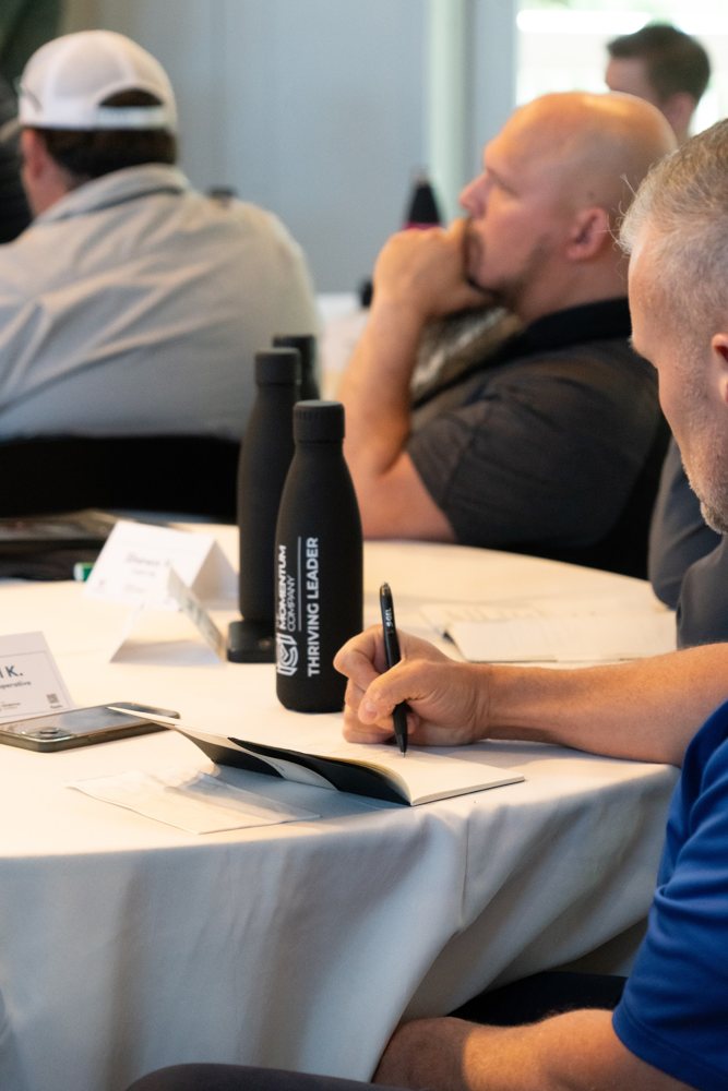 A sales leader writing during a session