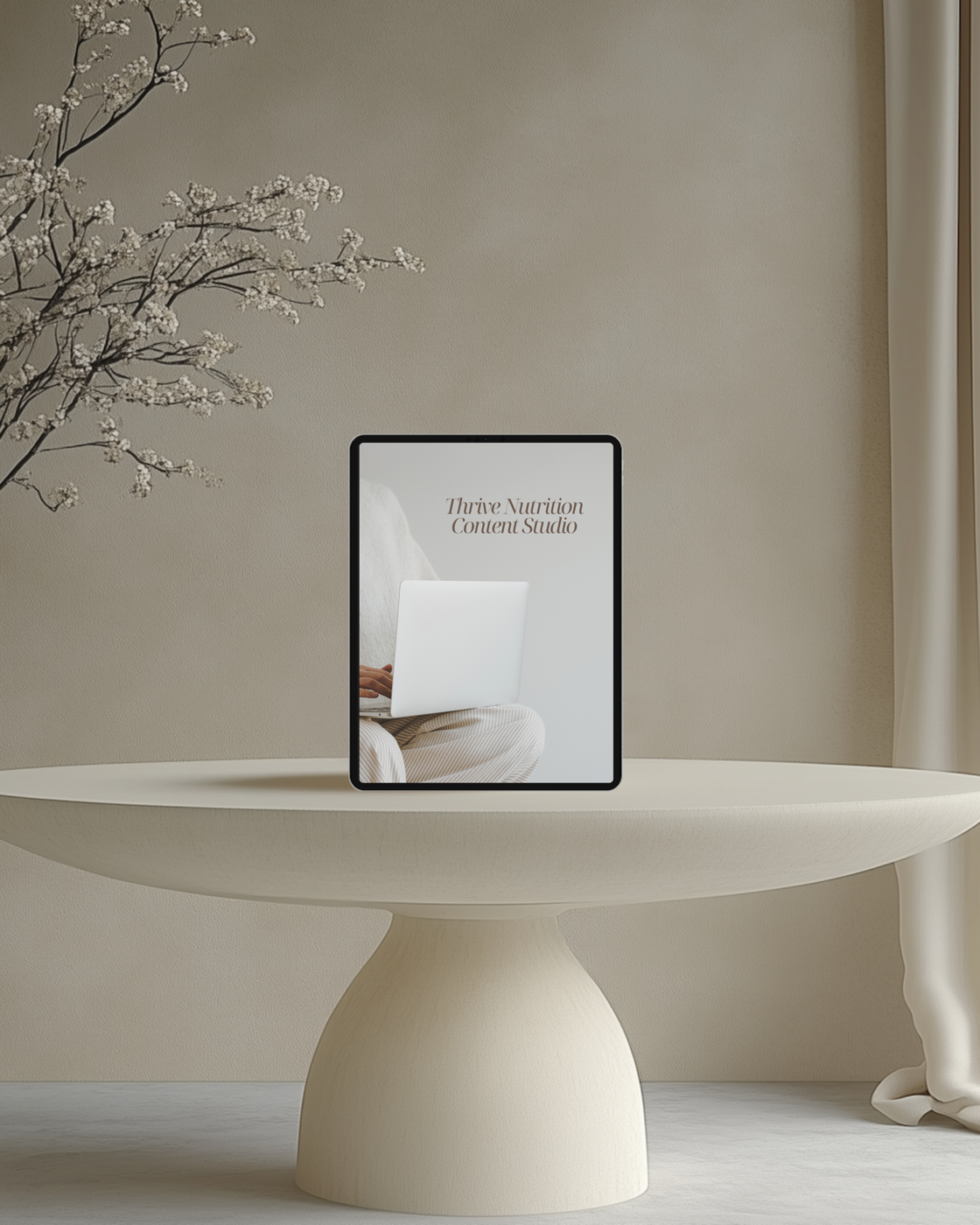 Thrive Nutrition Content Studio shown on a tablet beside spring blossoms