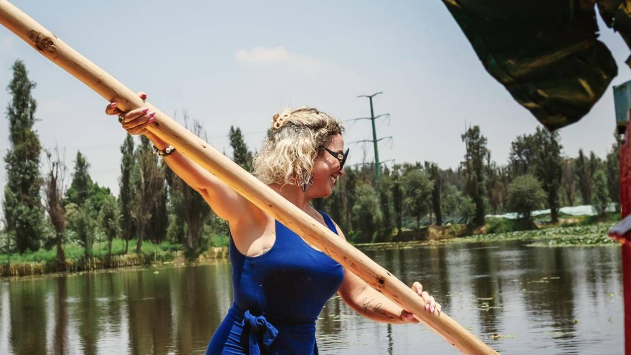 Daniele poling a trajinera through the canals of Xochimilco, Mexico City