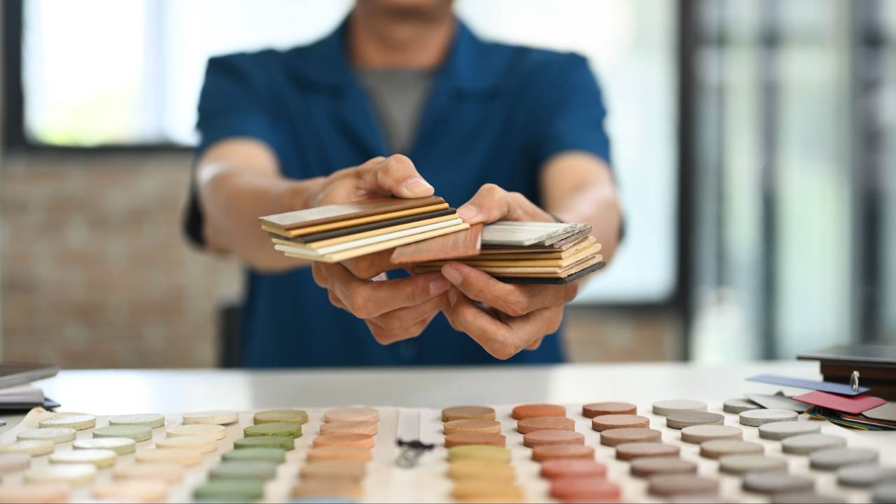 Man holding floor samples