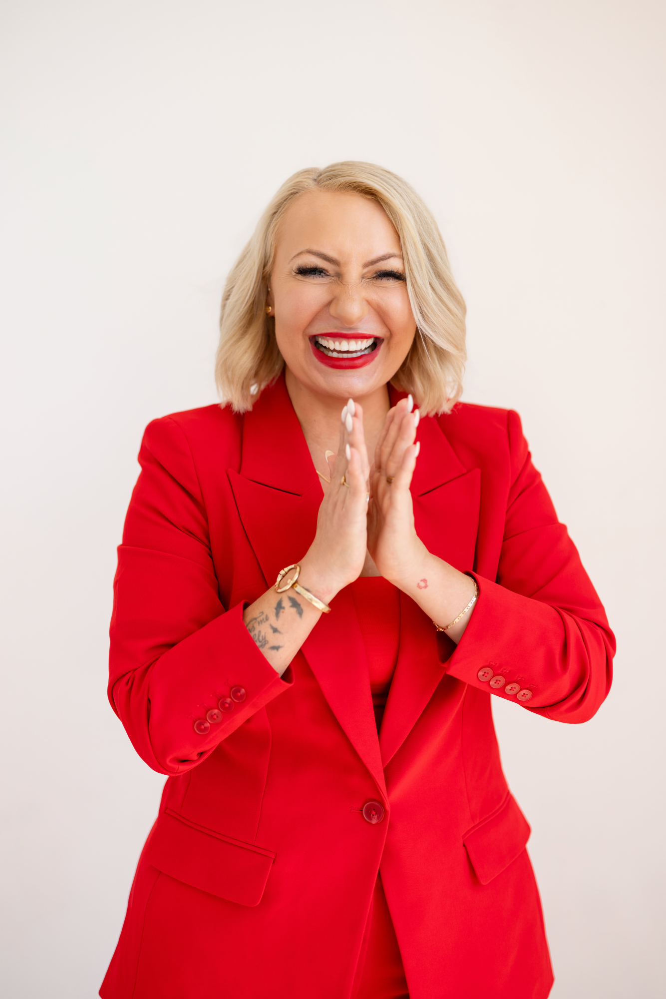 Miranda Dancisin laughing in a red suit
