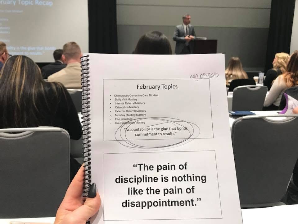 Miranda's seminar notebook open to a page that reads The pain of discipline is nothing like the pain of disappointment