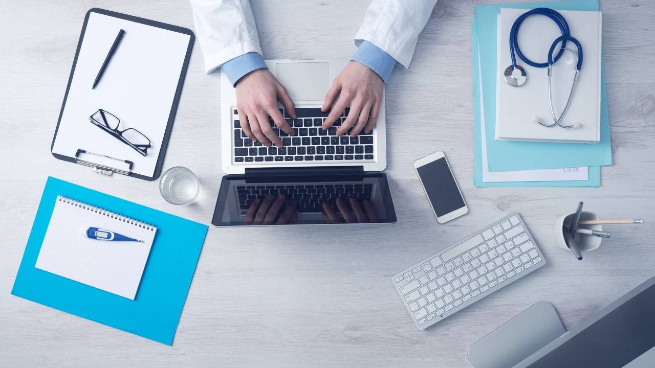 medical professional at desk on computer
