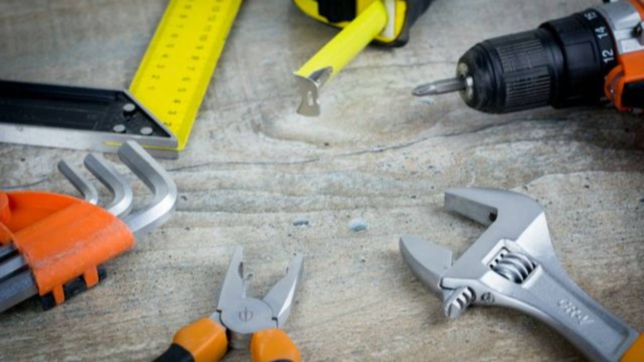 A set of tools lies on a table to illustrate the concept of maintenance
