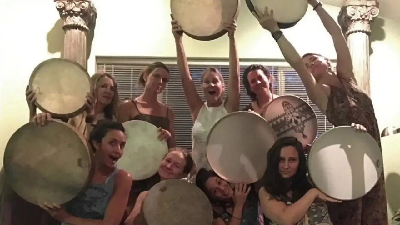krista holland with a group of frame drummers width="1280" height="720"px