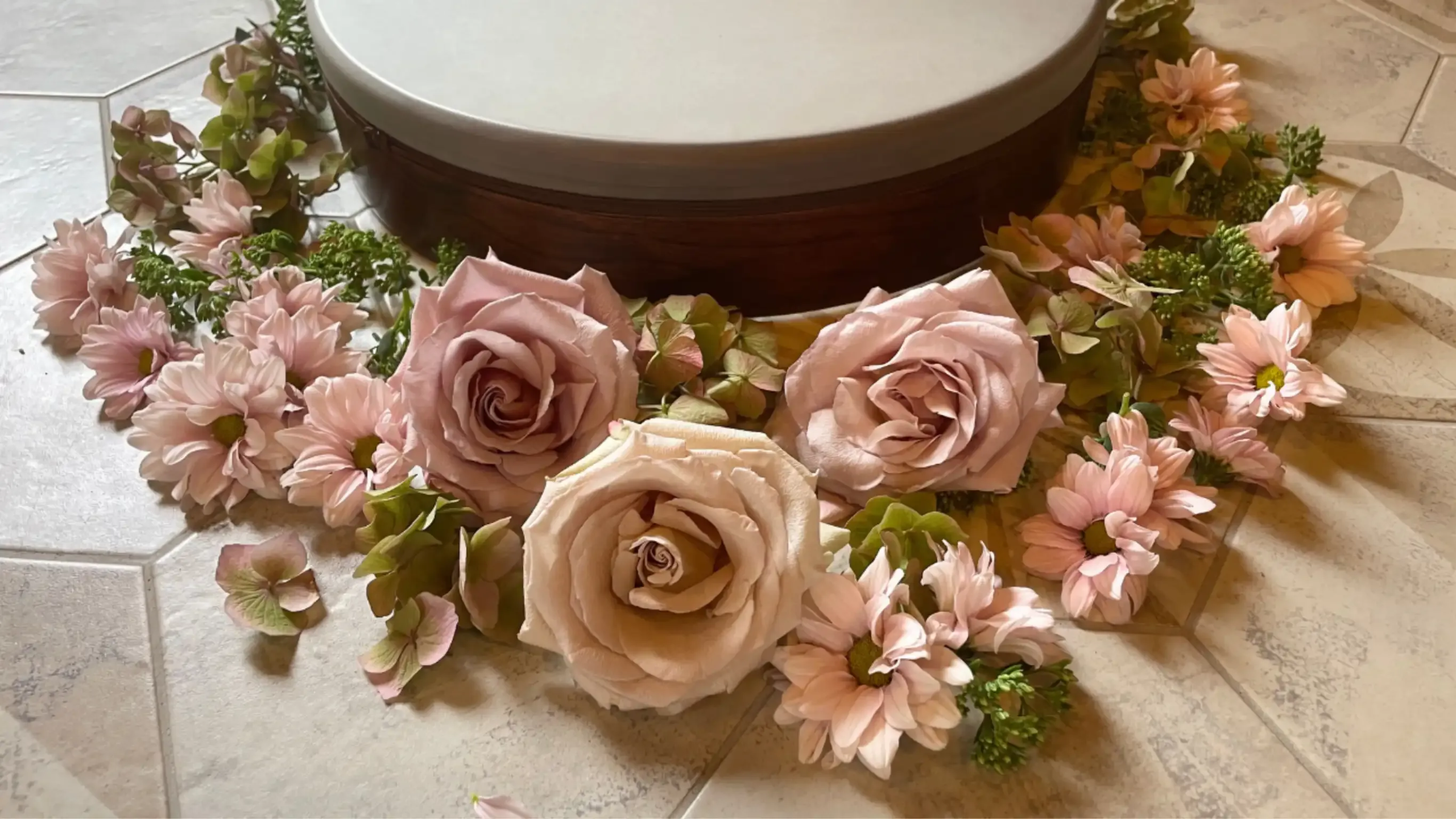 A "still life" of a frame drum surrounded by beautiful dusty pick roses
