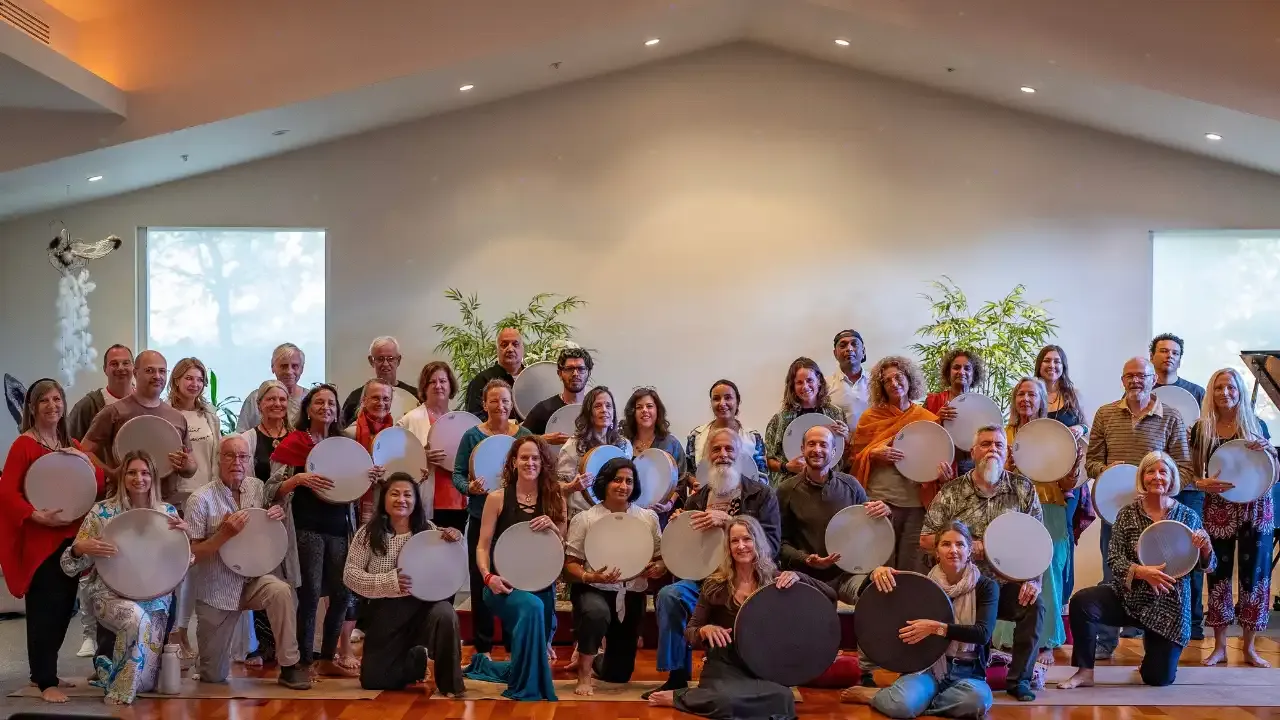 Krista Holland and a group of 30 frame drummers holding their frame drums at a retreat in Sedona, Arizona