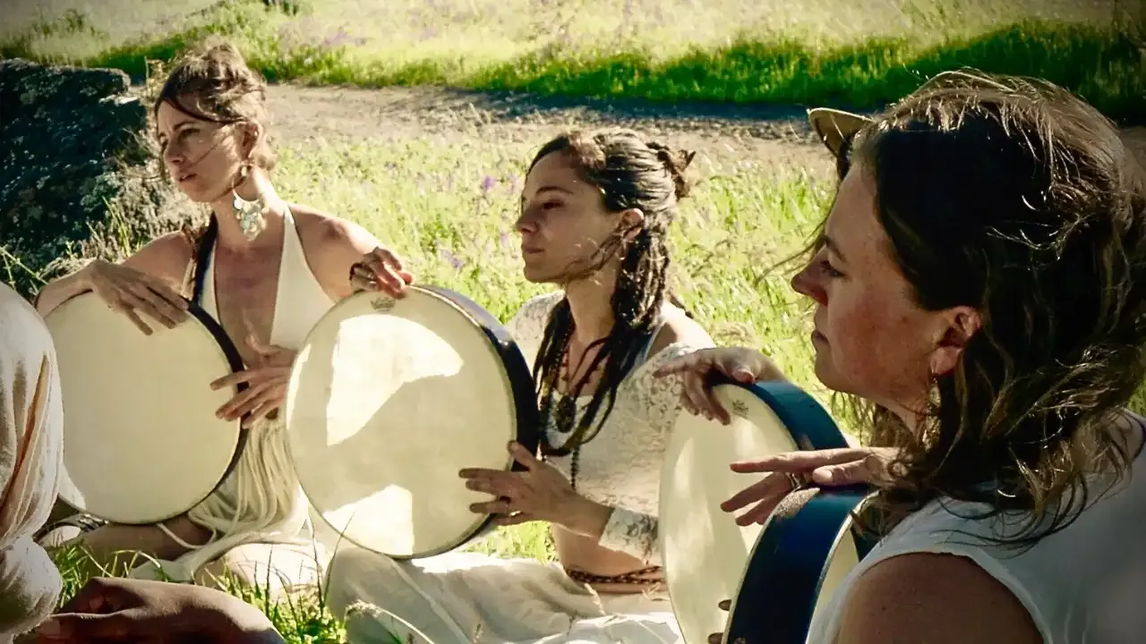 Krista Holland's frame drum academy with Jumana Sophia and three women sacred drumming in a  field during summer solstice