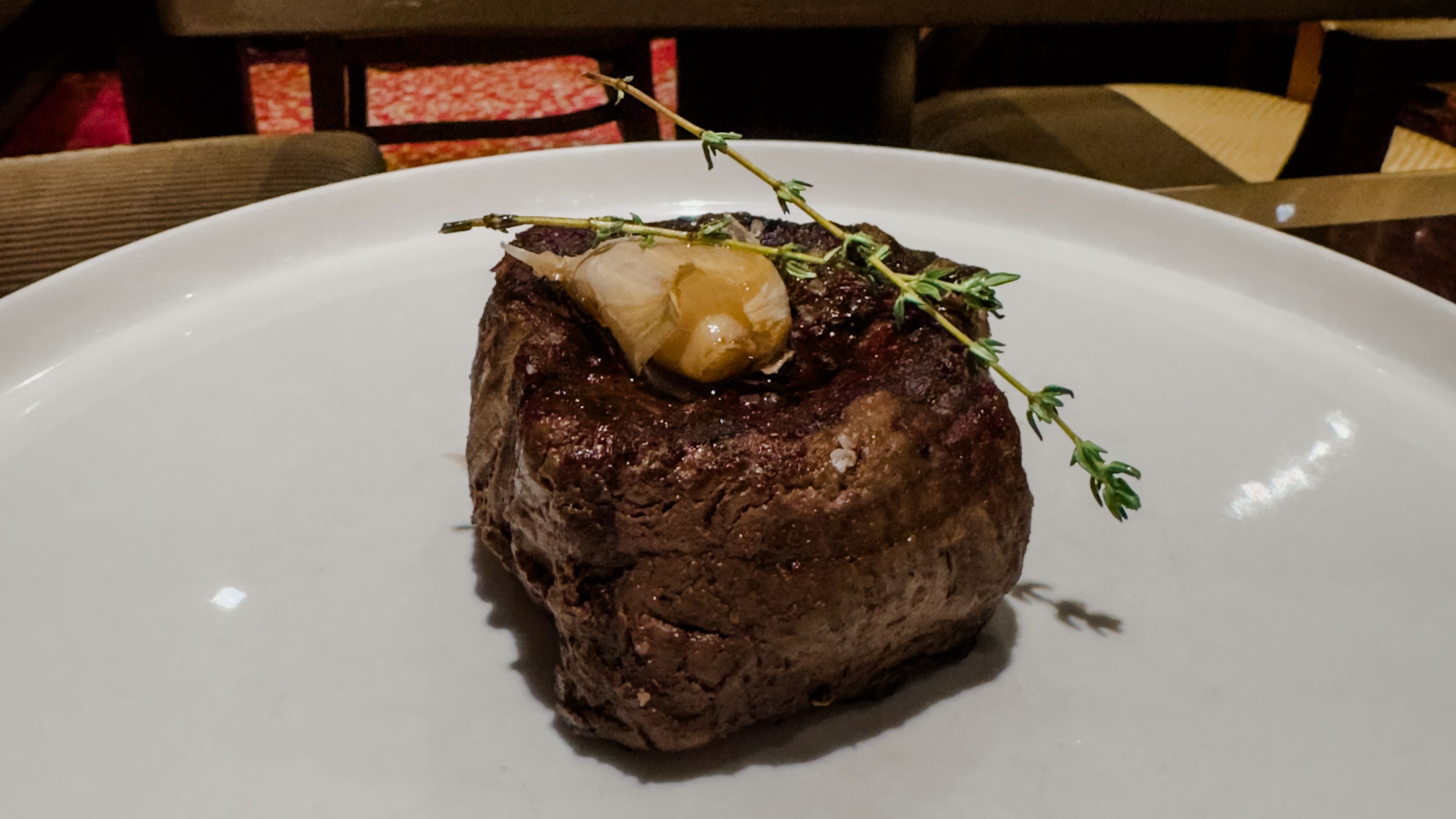 A cut of steak on a cruise ship specialty restaurant which comes at an additional cost