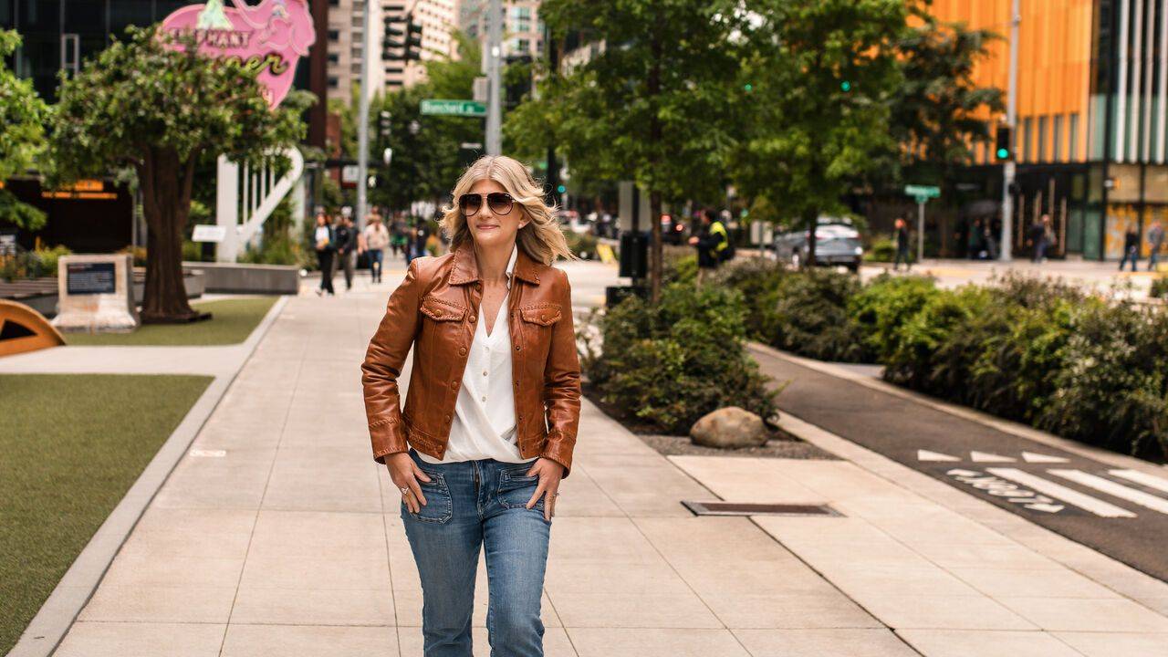 Stacey Salyer walking alone down a quiet city path