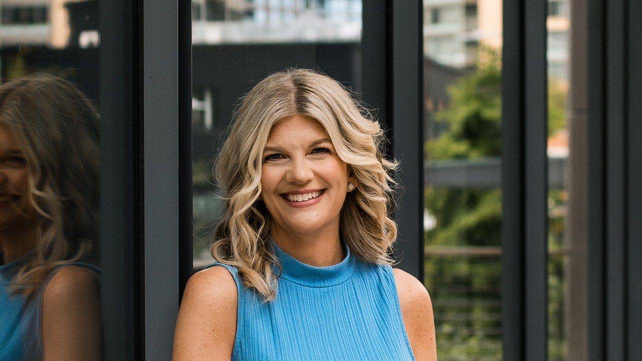Stacey Salyer smiling in a blue top, host of The Stacey Salyer Show.