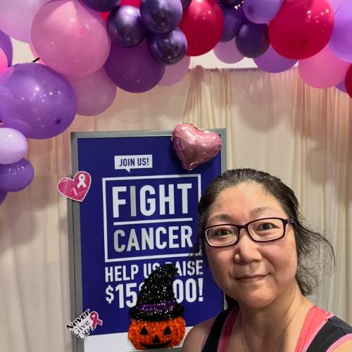 Noriko Abenojar at In-Shape Fitness Fights Cancer display Noriko Abenojar at In-Shape Fitness in front of a “Fitness Fights Cancer” sign, reflecting on flexibility and sciatic nerve stretches.
